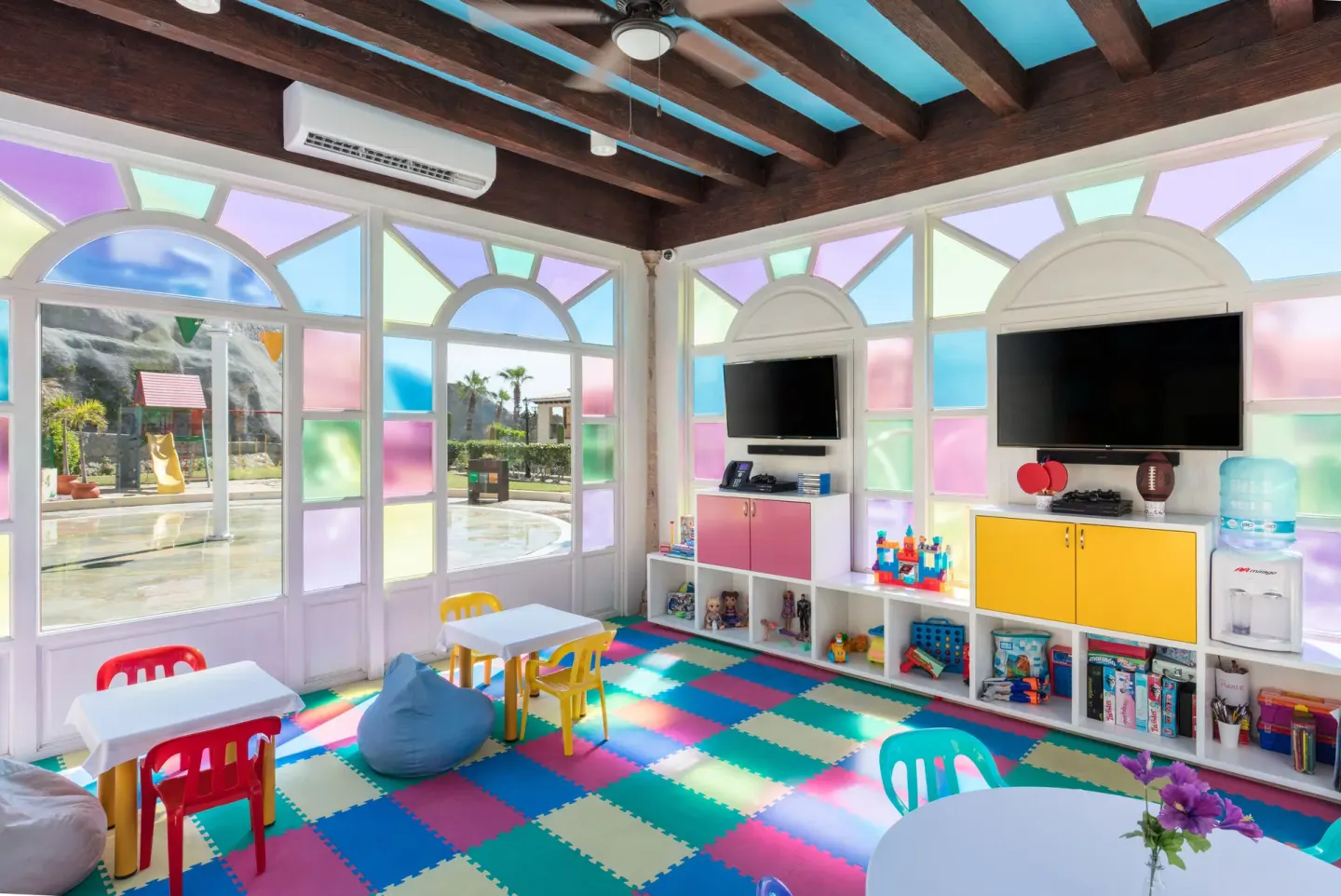 Colorful kids club playroom with toys and tables at El Encanto at Hacienda Encantada.