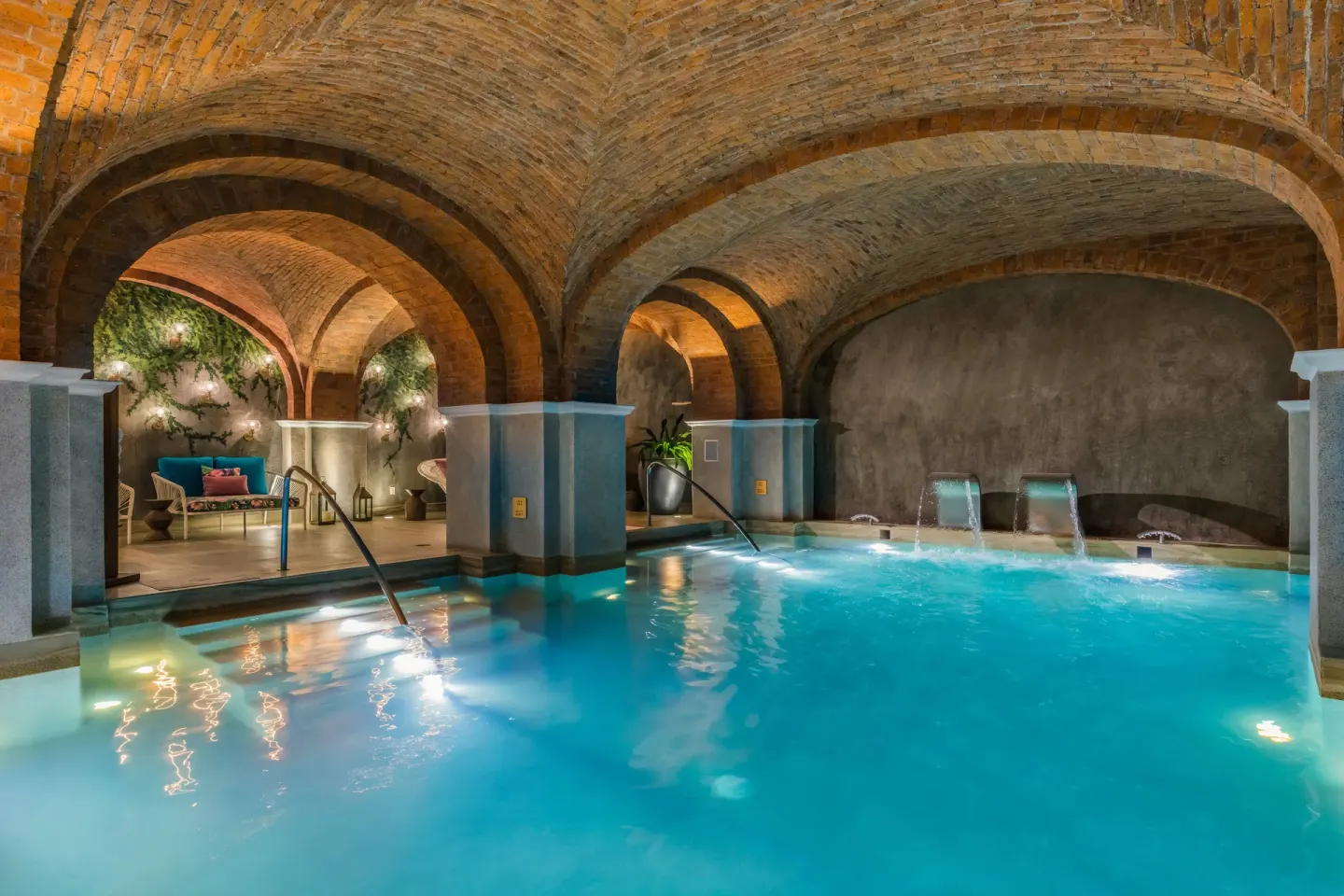 Indoor spa pool beneath brick arches at El Encanto at Hacienda Encantada