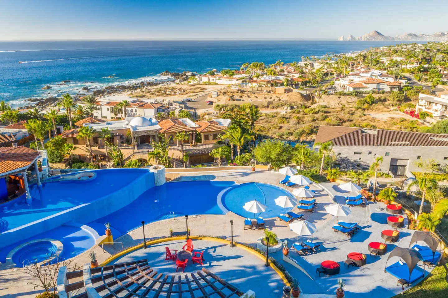 Resort pool, coastline, and ocean panorama at El Encanto at Hacienda Encantada.