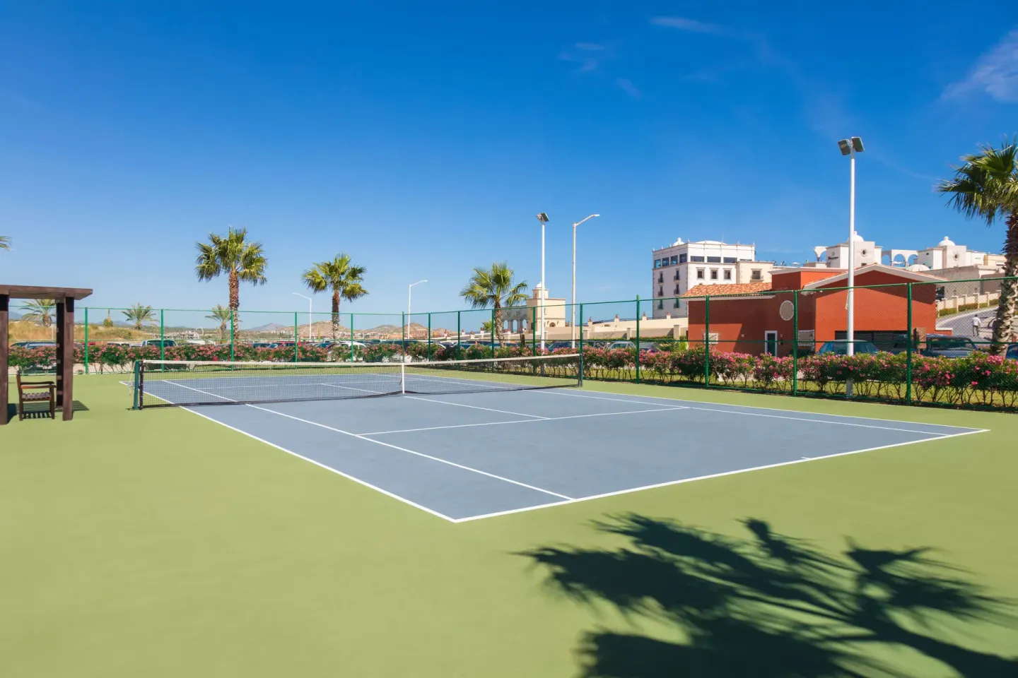 Outdoor tennis court with palms at El Encanto at Hacienda Encantada