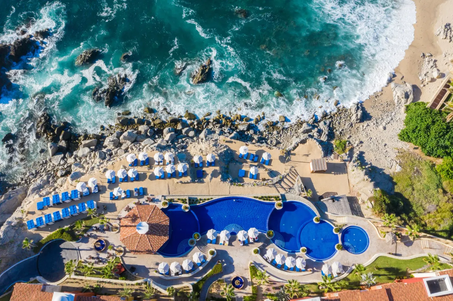 Overhead view of the beachfront pool and rocky surf at El Encanto at Hacienda Encantada.