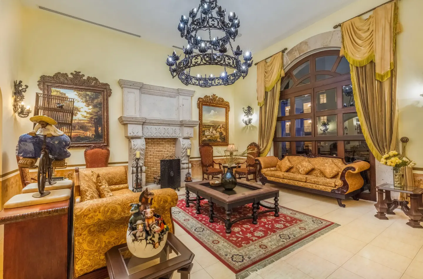 Traditional lounge with fireplace and gold seating at El Encanto at Hacienda Encantada.