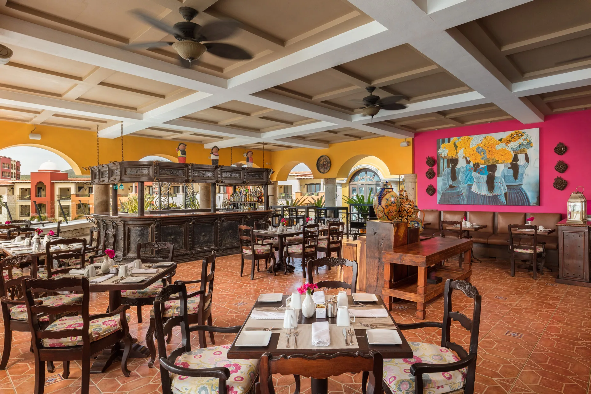 Colorful dining room with carved bar at El Encanto at Hacienda Encantada.