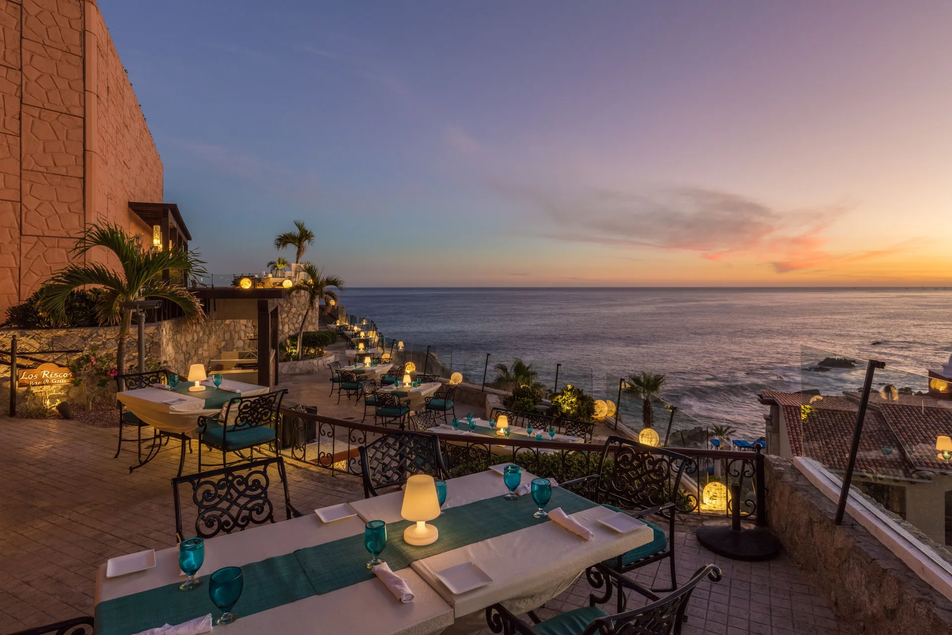 Los Riscos terrace at El Encanto at Hacienda Encantada set for sunset dining above the ocean.
