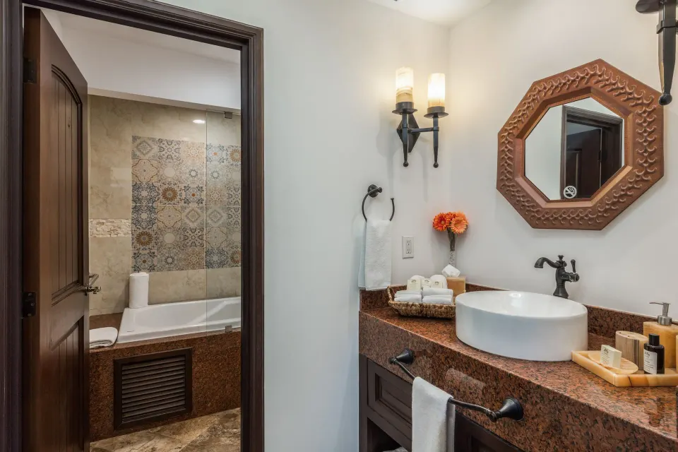 Luxury Suite bathroom at El Encanto at Hacienda Encantada with vessel sink and bathtub beyond.
