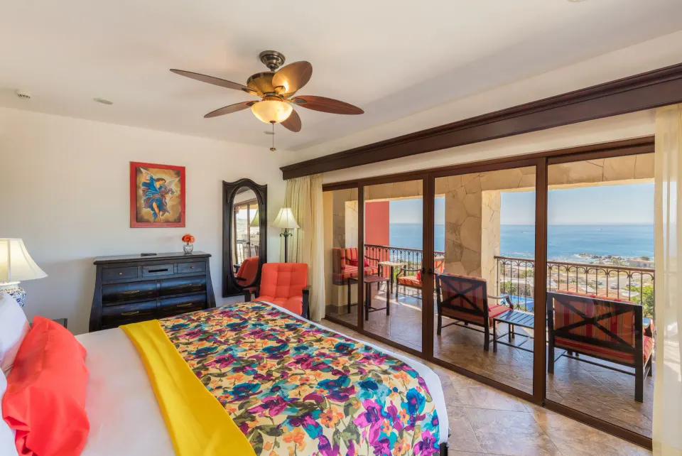 Luxury Suite king bed with ocean-facing balcony at El Encanto at Hacienda Encantada.