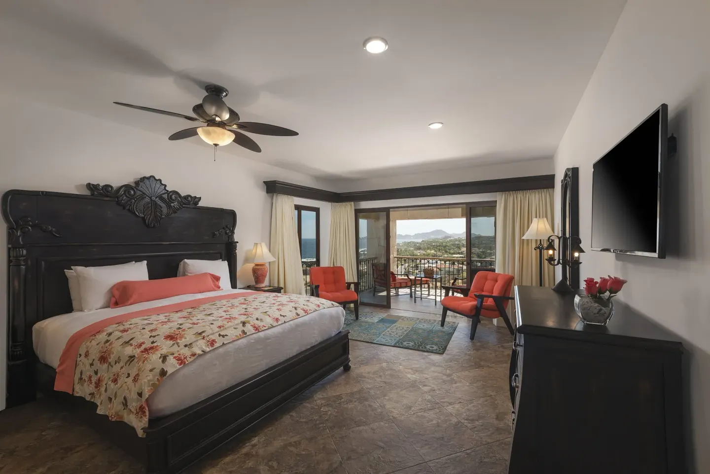 Premium Suite king bedroom with orange chairs at El Encanto at Hacienda Encantada.