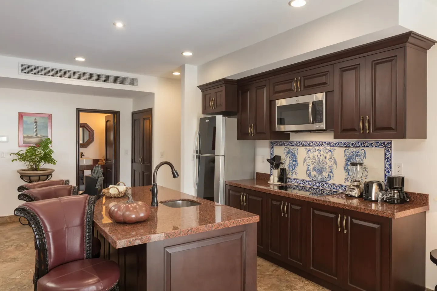 Premium Suite kitchen with island and dark cabinetry at El Encanto at Hacienda Encantada.