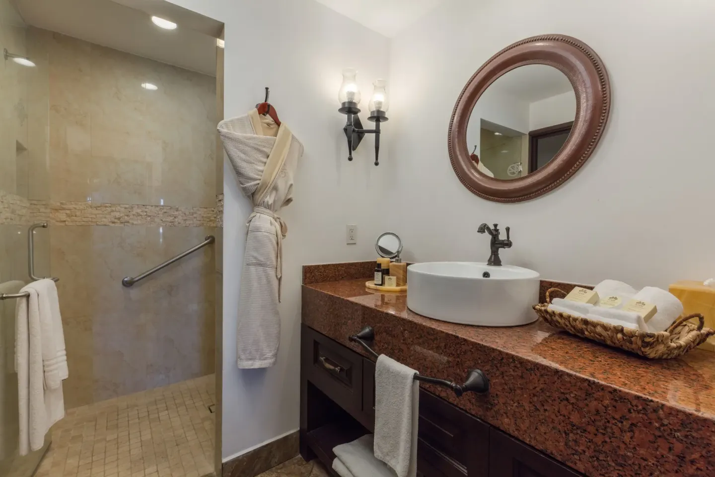 Studio Garden View bathroom sink, robe, and tiled shower at El Encanto at Hacienda Encantada.