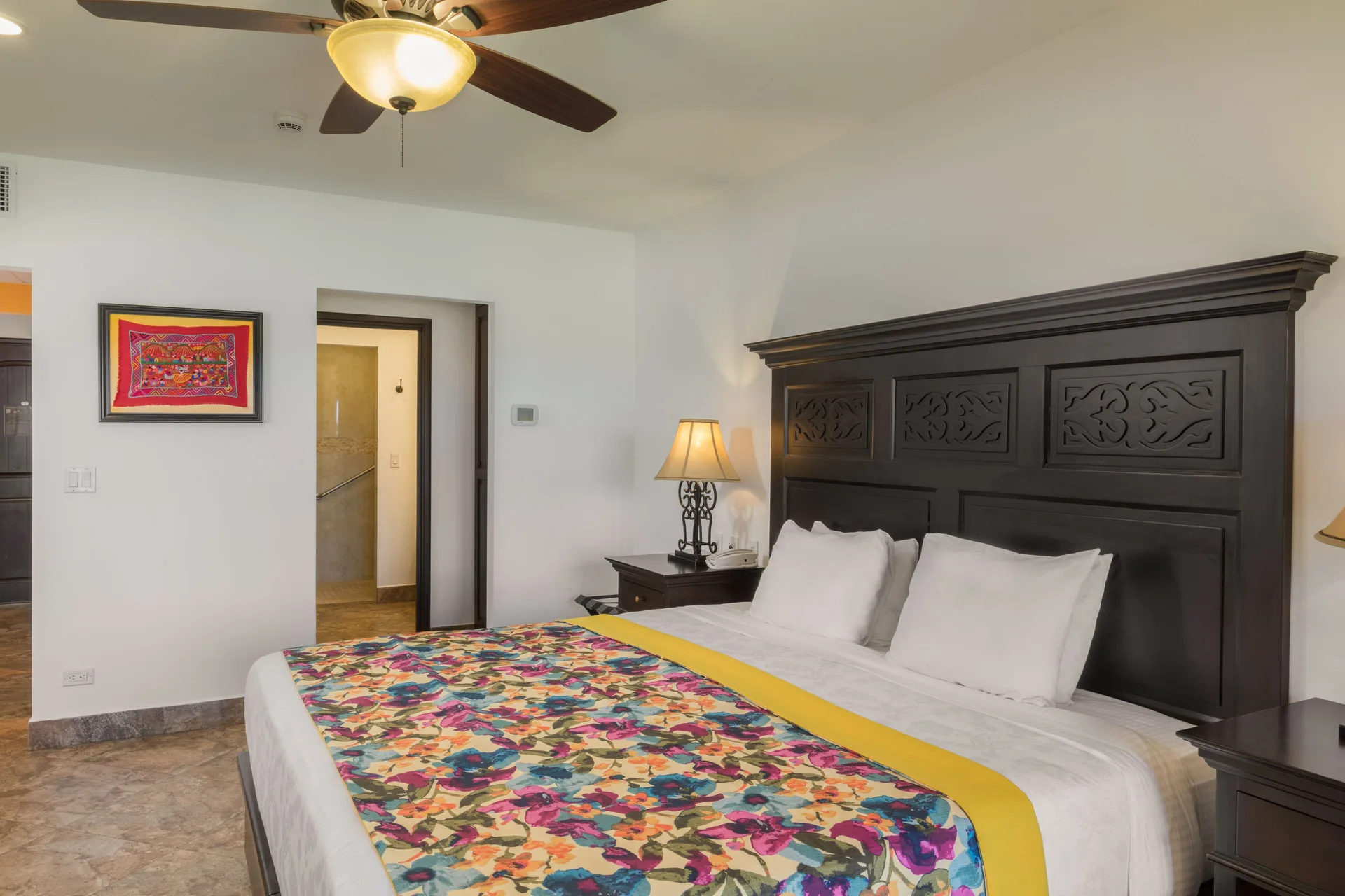 Studio Garden View king bed and dark carved headboard at El Encanto at Hacienda Encantada.
