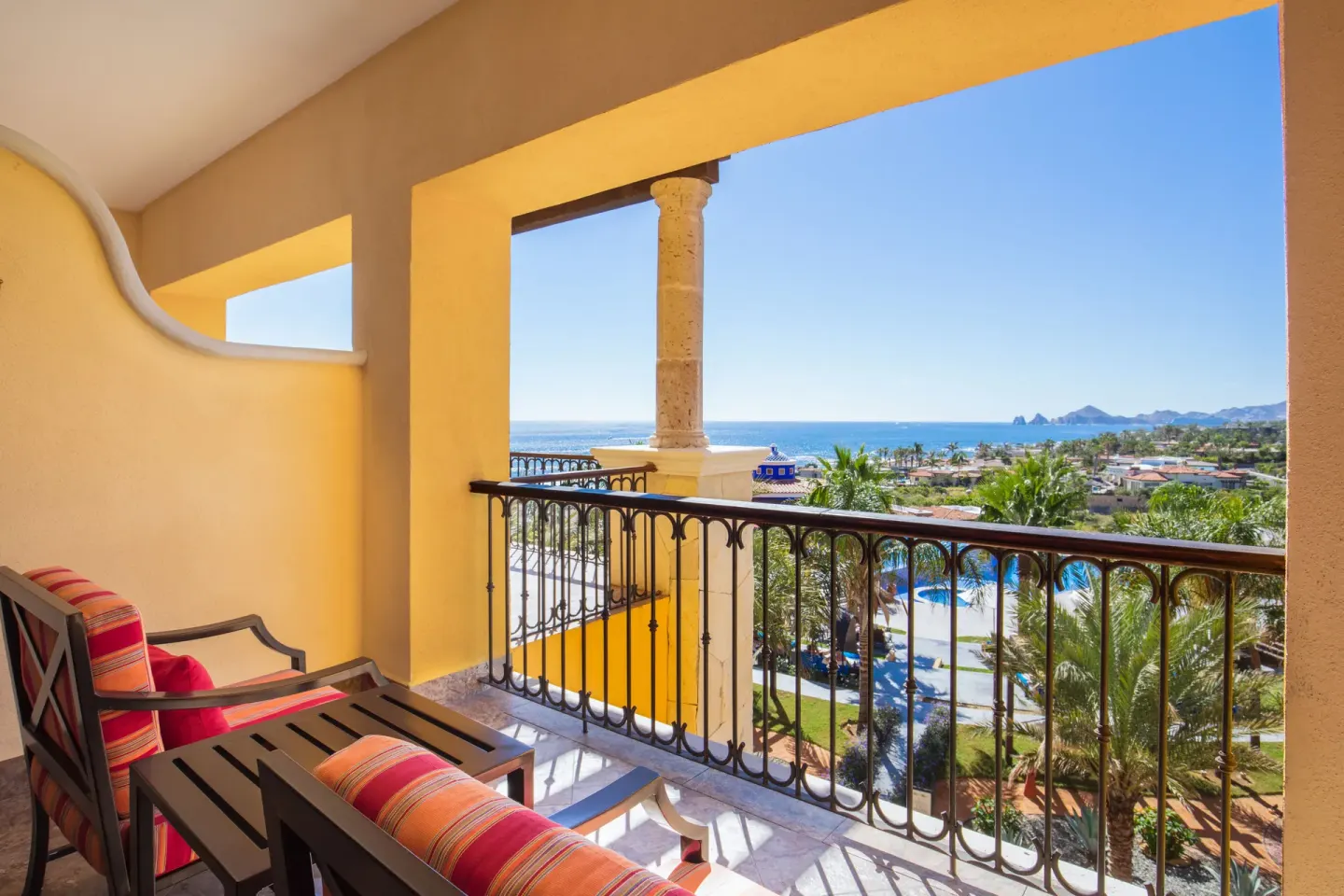 Studio ocean view balcony with cushioned seating at El Encanto at Hacienda Encantada.