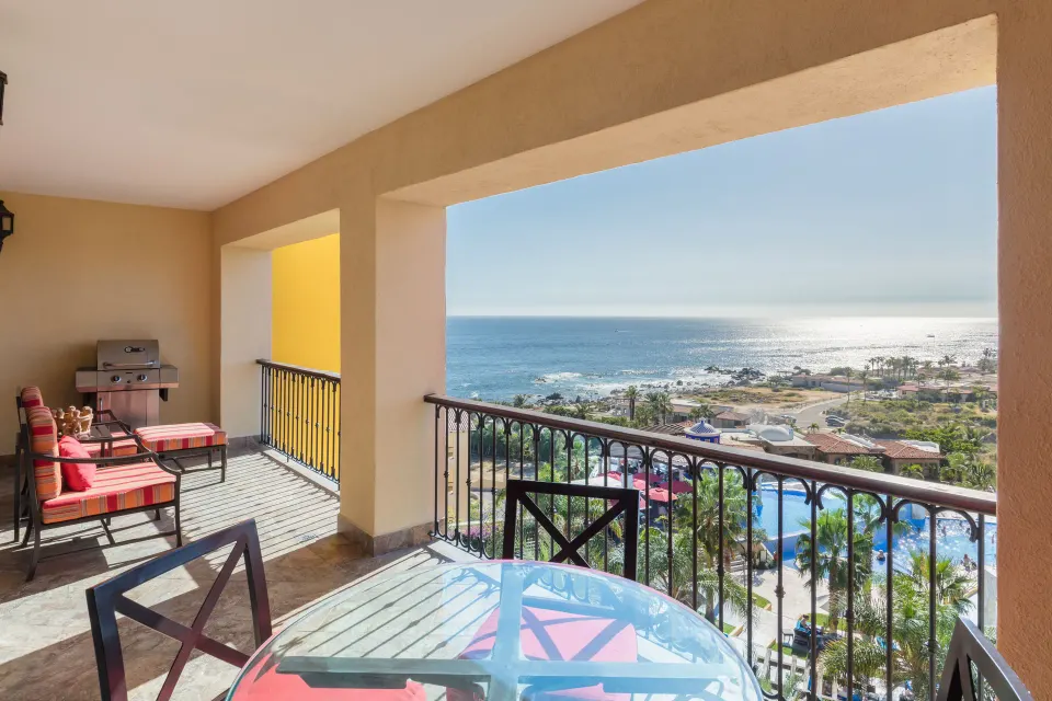 Ocean view studio balcony with table, chairs, and grill at El Encanto at Hacienda Encantada.