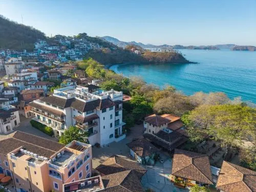 Santarena Hotel at Las Catalinas boutique hotel with rooftop pool and coastal village architecture in Las Catalinas, Costa Rica.