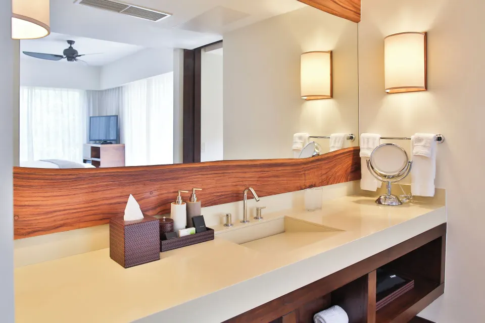 Light-colored vanity with mirror reflecting the bedroom at El Mangroove Papagayo