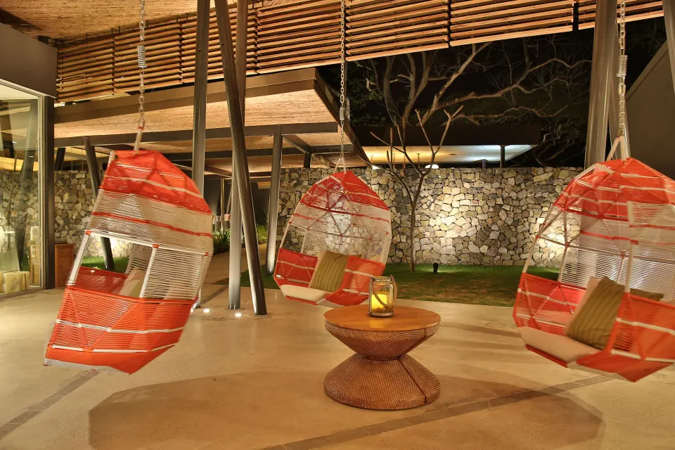 Hanging swing chairs in an open-air seating area at El Mangroove Papagayo