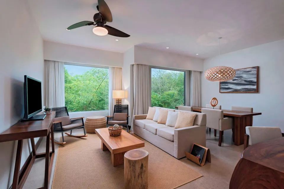 Wide living room with sofa and large windows at El Mangroove Papagayo