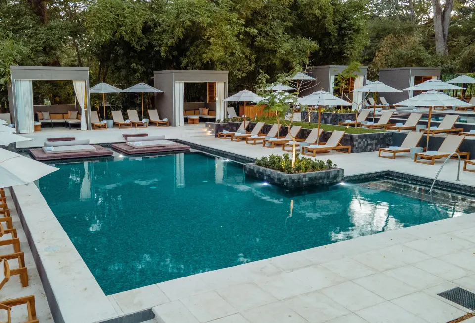 Poolside cabanas and loungers beside a small pool at El Mangroove Papagayo.