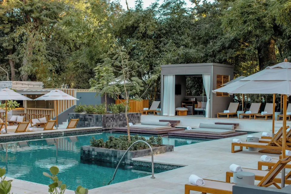 Tiered rectangular pools with a private cabana and loungers at El Mangroove Papagayo