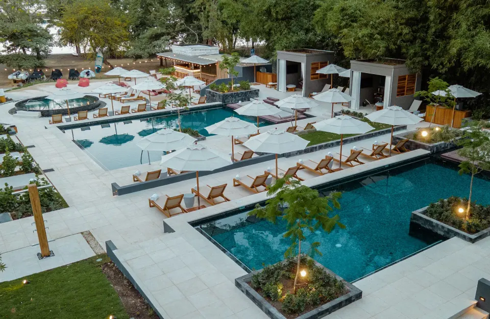 Tiered pool terraces with cabanas and loungers at El Mangroove Papagayo