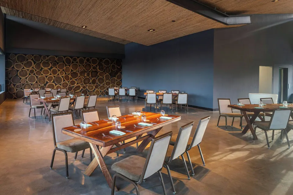 Set dining tables in a modern open event space at El Mangroove Papagayo