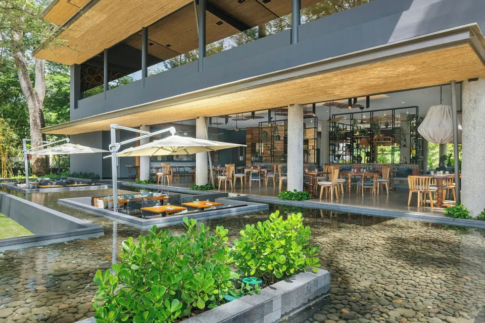 Daytime view of open restaurant terrace and water features at El Mangroove Papagayo