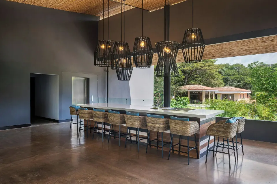 Long indoor bar counter with pendant lights at El Mangroove Papagayo