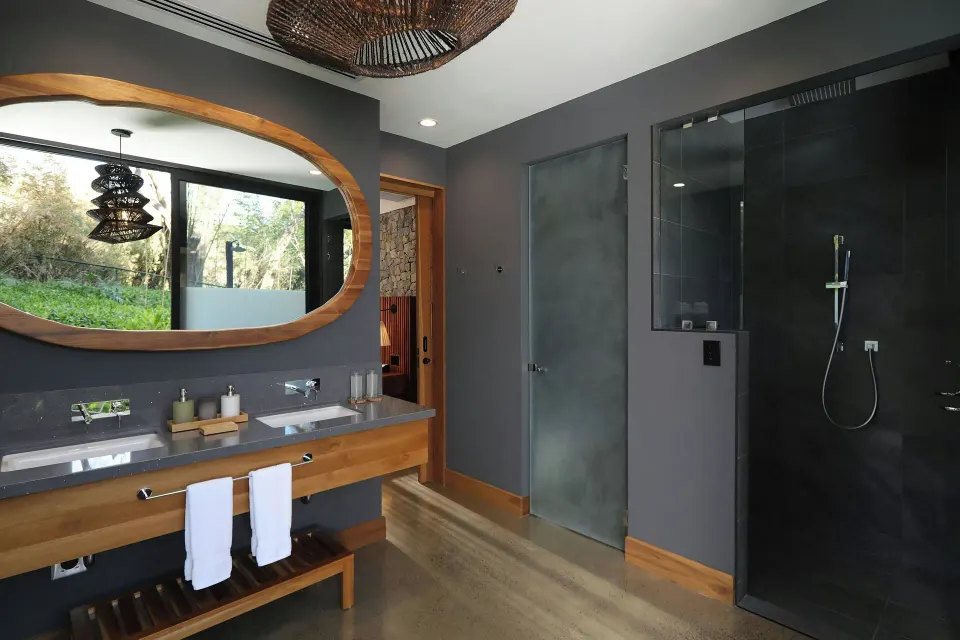 Bathroom vanity, large mirror and glass shower in Balcony Garden View Three-Bedroom Villa at El Mangroove Papagayo