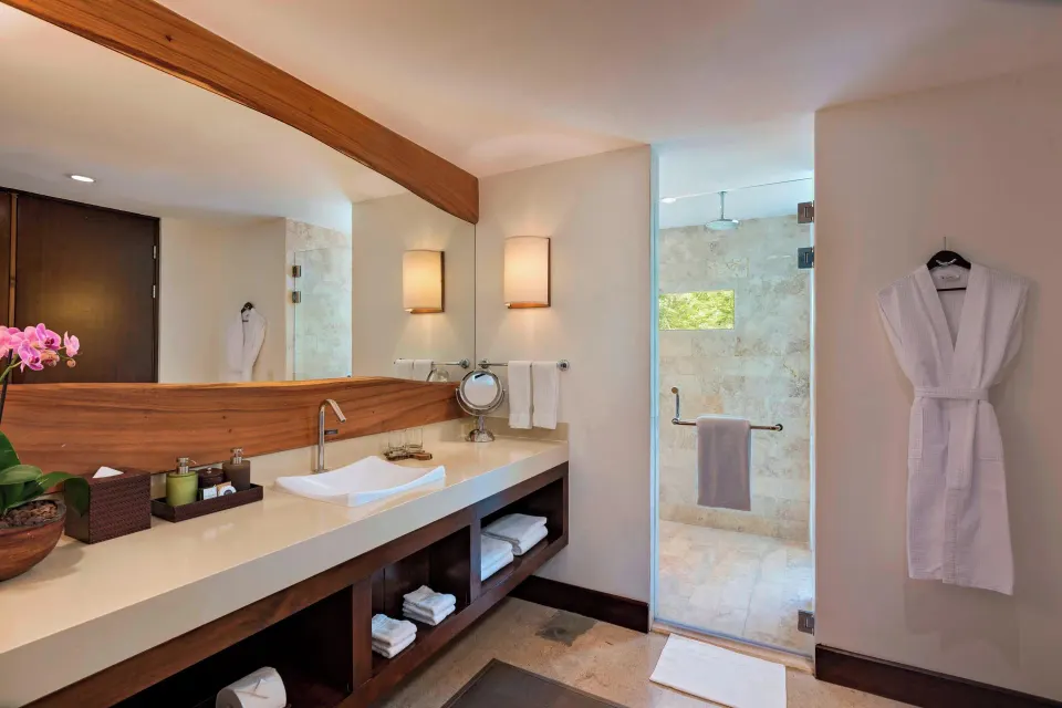 Suite bathroom vanity and shower entrance at El Mangroove Papagayo