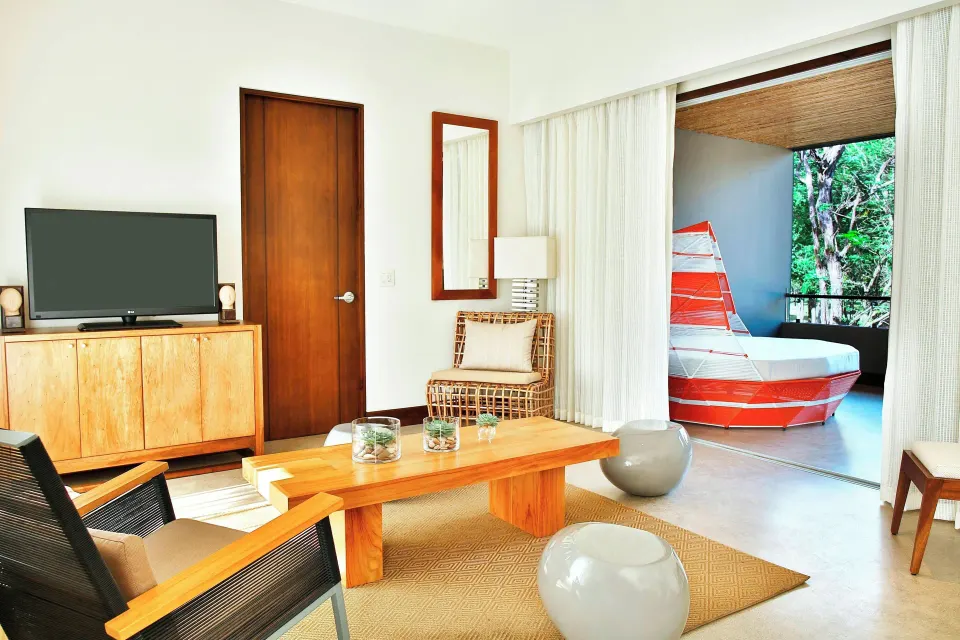 Living area of Grand Resort View One-Bedroom Suite with TV and daybed at El Mangroove Papagayo