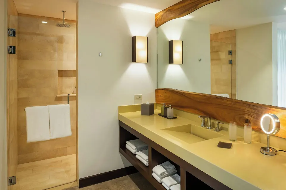 Double-sink vanity and glass shower in a suite bathroom at El Mangroove Papagayo