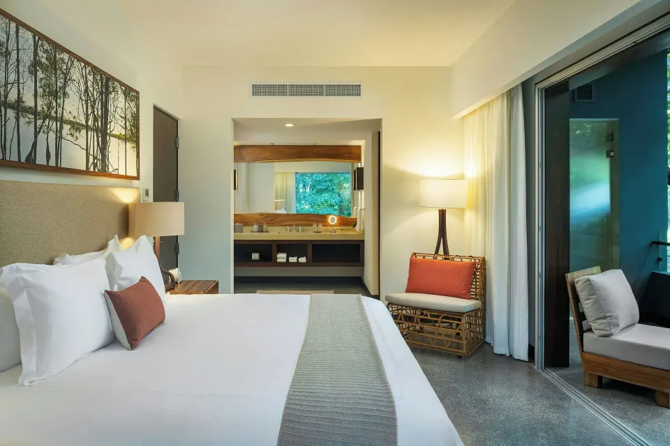 Superior Balcony One-Bedroom Suite showing bed and vanity area at El Mangroove Papagayo
