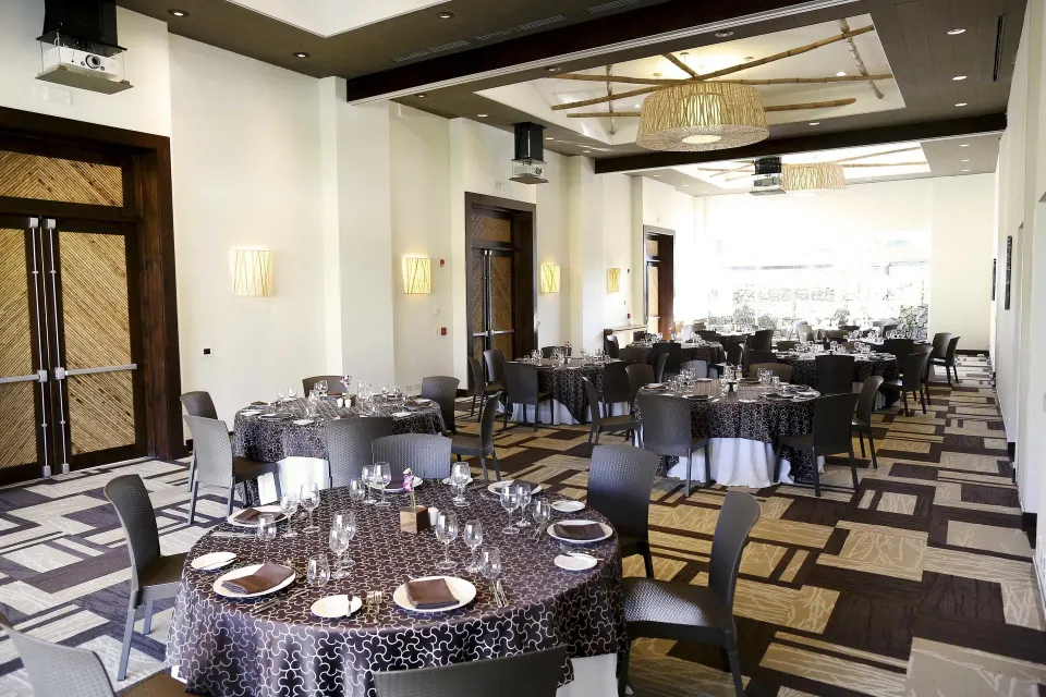 Elegant indoor banquet room set for dining at El Mangroove Papagayo