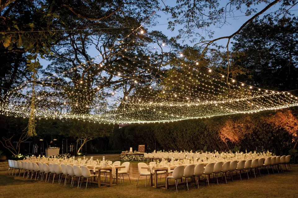 Evening outdoor banquet under a canopy of string lights at El Mangroove Papagayo