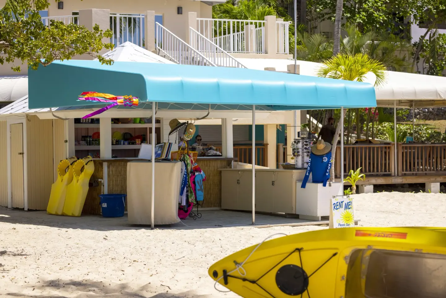 Beach rental hut with kayaks and gear on the sand at Elysian Beach Resort.