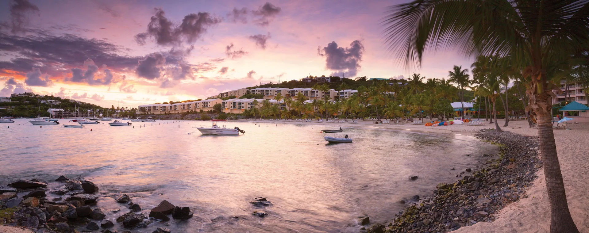 Panoramic sunset over the beach and bay at Elysian Beach Resort.
