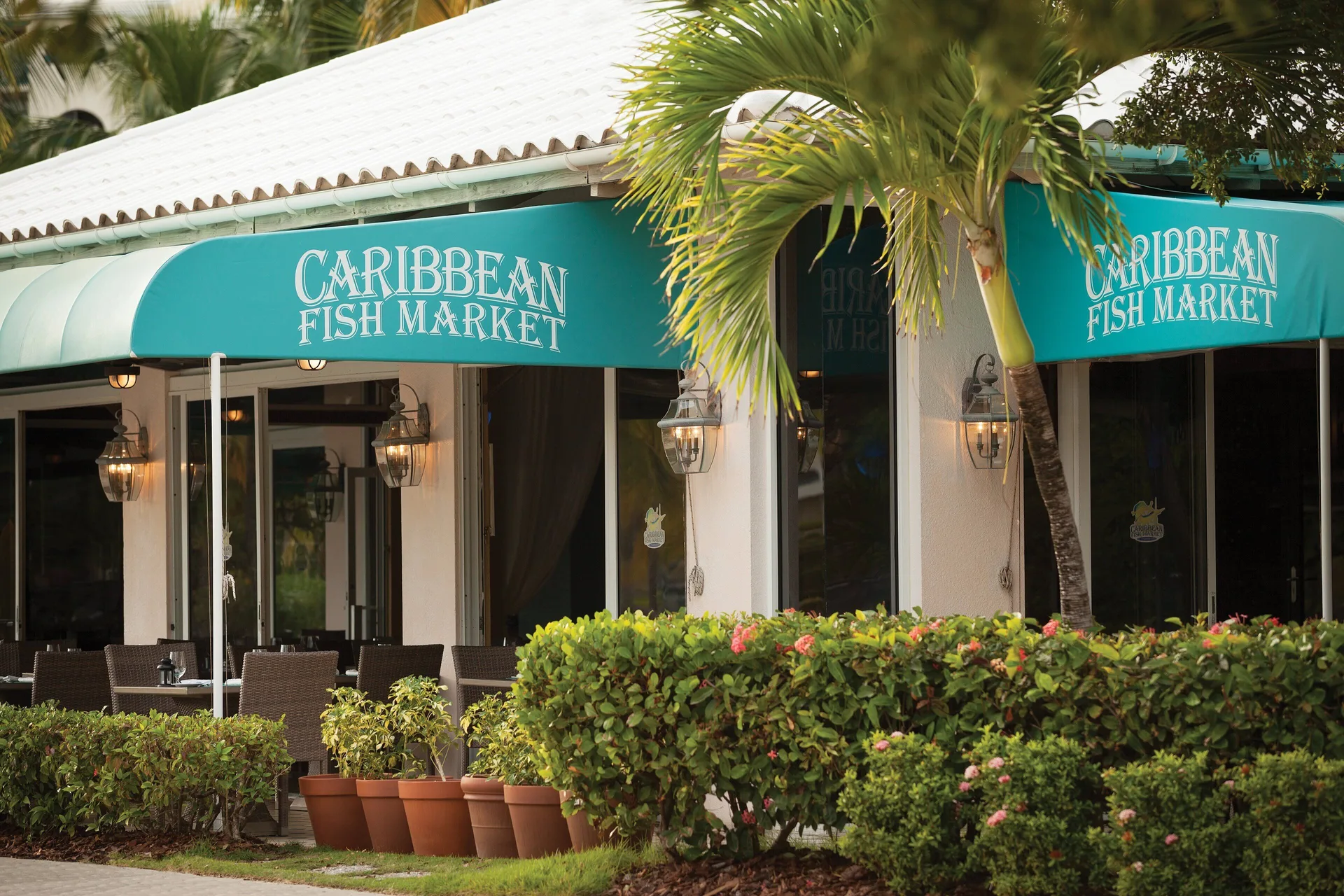 Caribbean Fish Market exterior with turquoise awnings at Elysian Beach Resort.