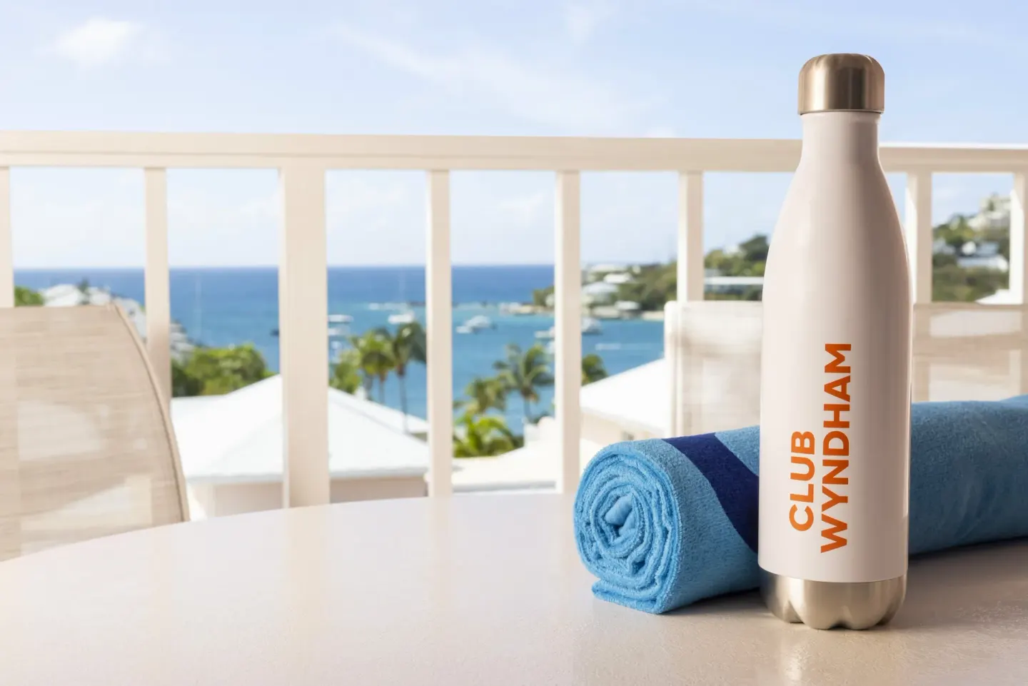 Standard Studio balcony with towel and water bottle at Elysian Beach Resort.