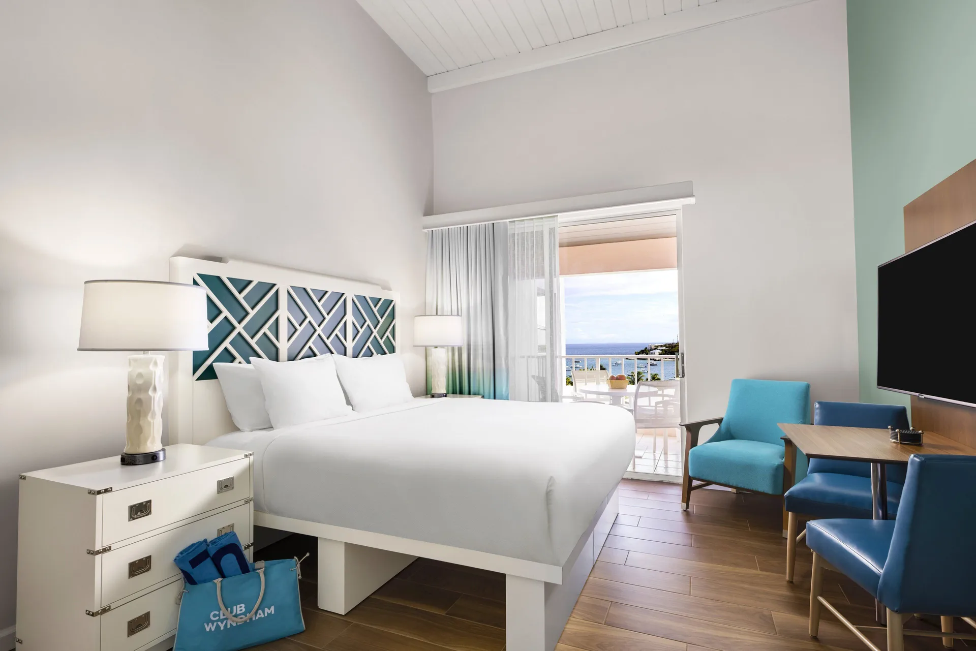 Standard Studio king bed and balcony view at Elysian Beach Resort.
