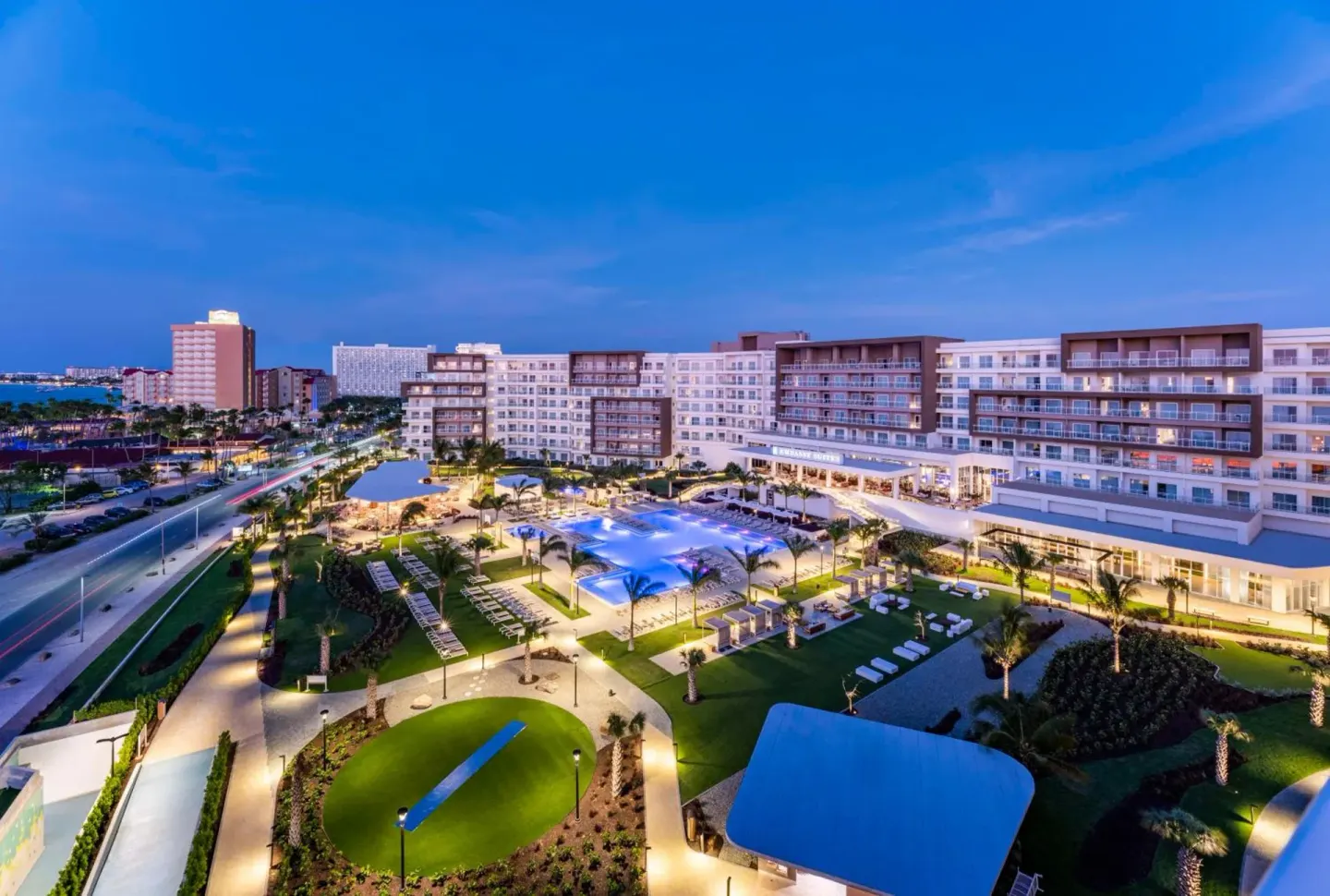 Aerial evening view of pools and resort grounds at Embassy Suites Aruba Beach Resort.
