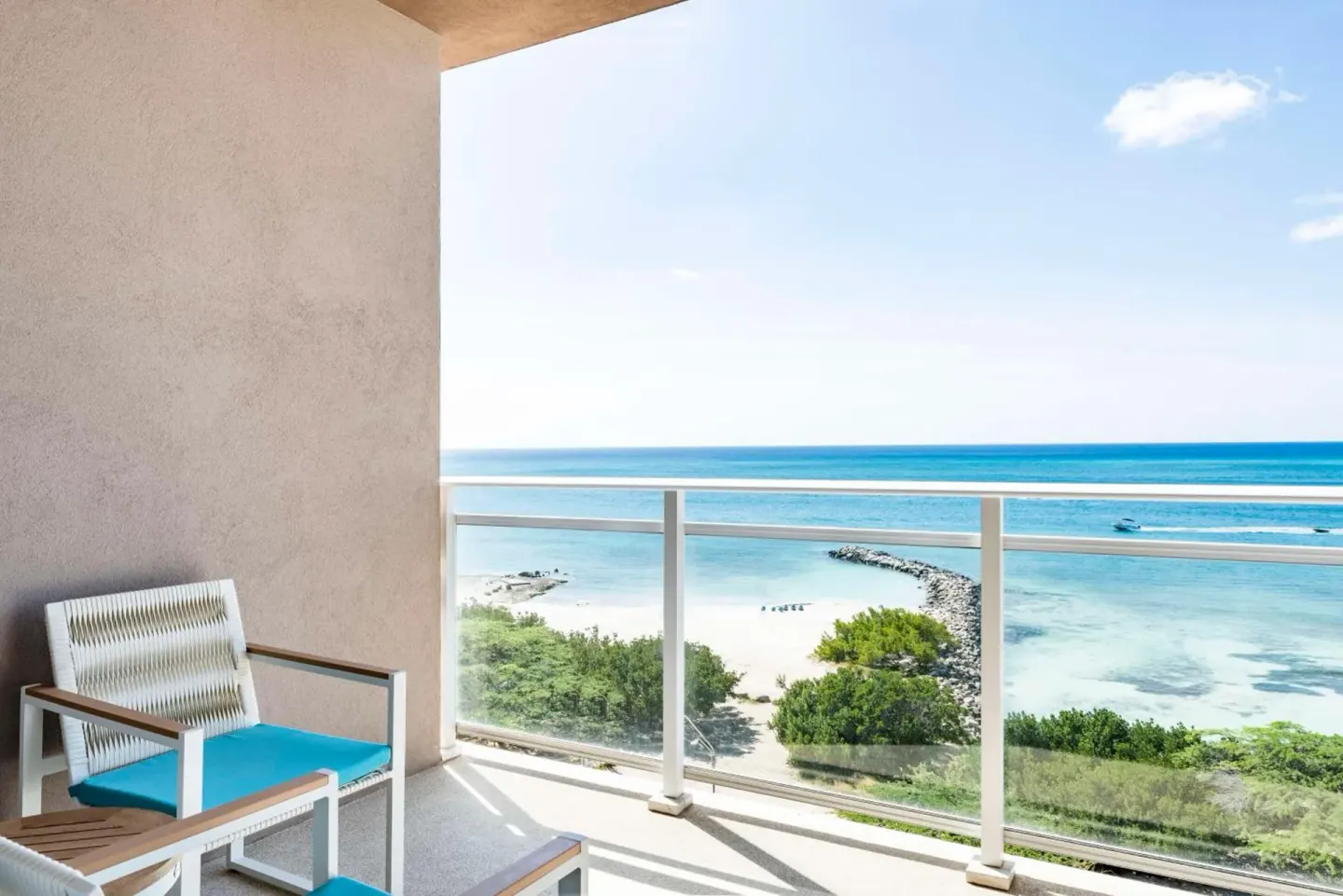 Balcony seating with ocean and beach views at Embassy Suites Aruba Beach Resort.