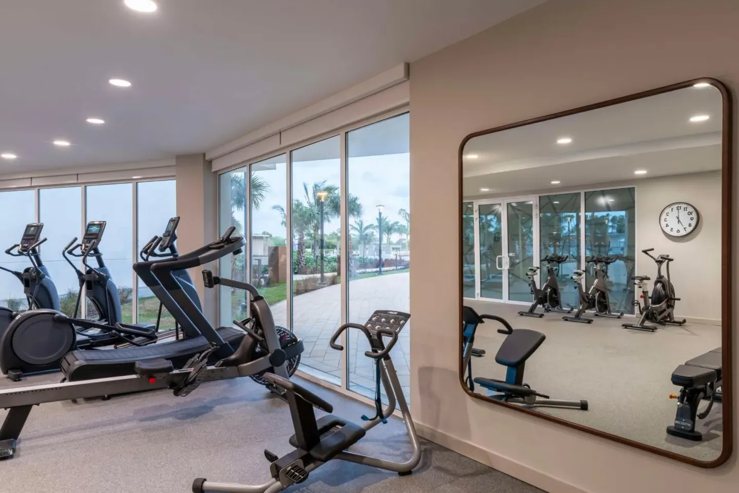 Fitness room with cardio machines and bikes at Embassy Suites Aruba Beach Resort.