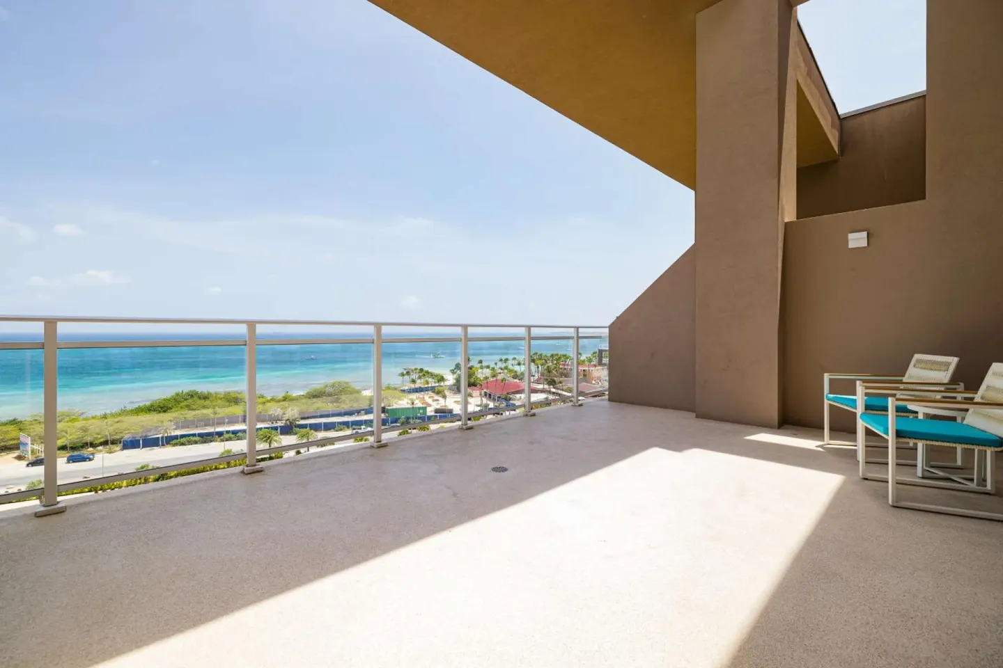 Spacious balcony with ocean view at Embassy Suites Aruba Beach Resort.