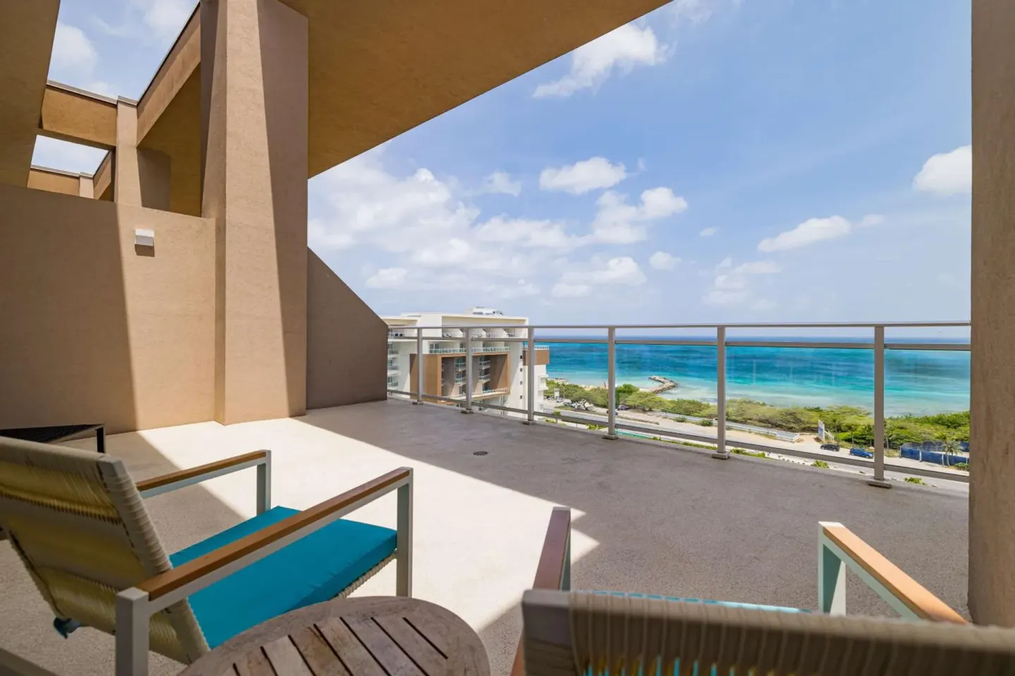 Balcony seating with ocean view at Embassy Suites Aruba Beach Resort.