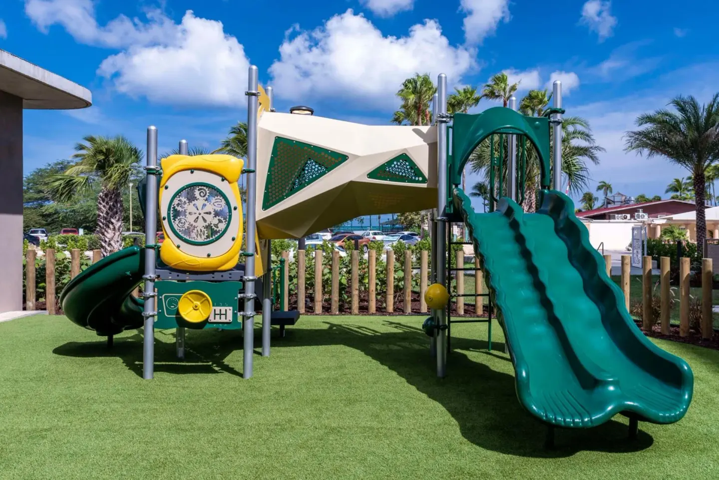 Children's outdoor play structure with slides at Embassy Suites Aruba Beach Resort.