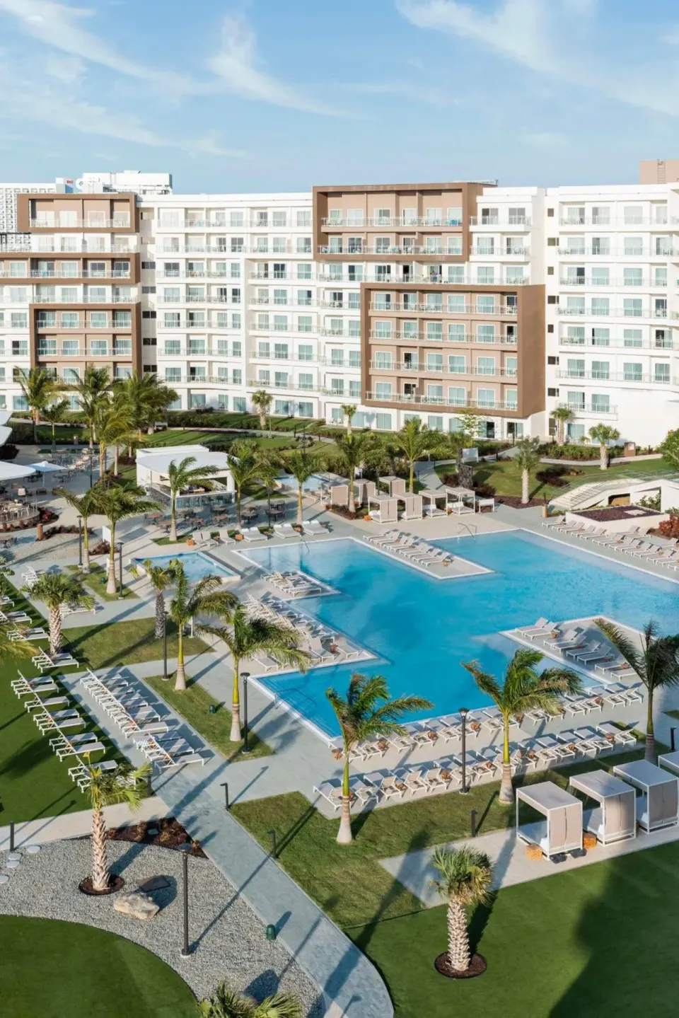 Aerial view of the pool courtyard and guest room balconies at Embassy Suites Aruba Beach Resort.