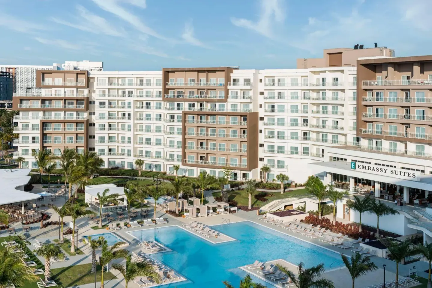 Resort buildings and pool courtyard at Embassy Suites Aruba Beach Resort.