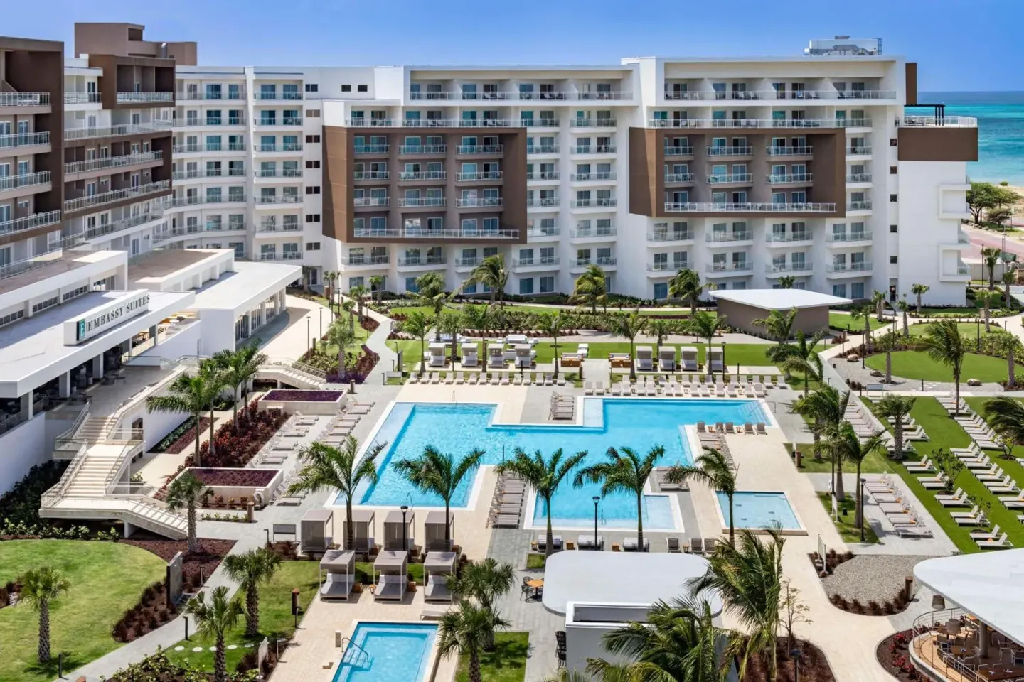 Aerial view of pools and resort grounds at Embassy Suites Aruba Beach Resort.
