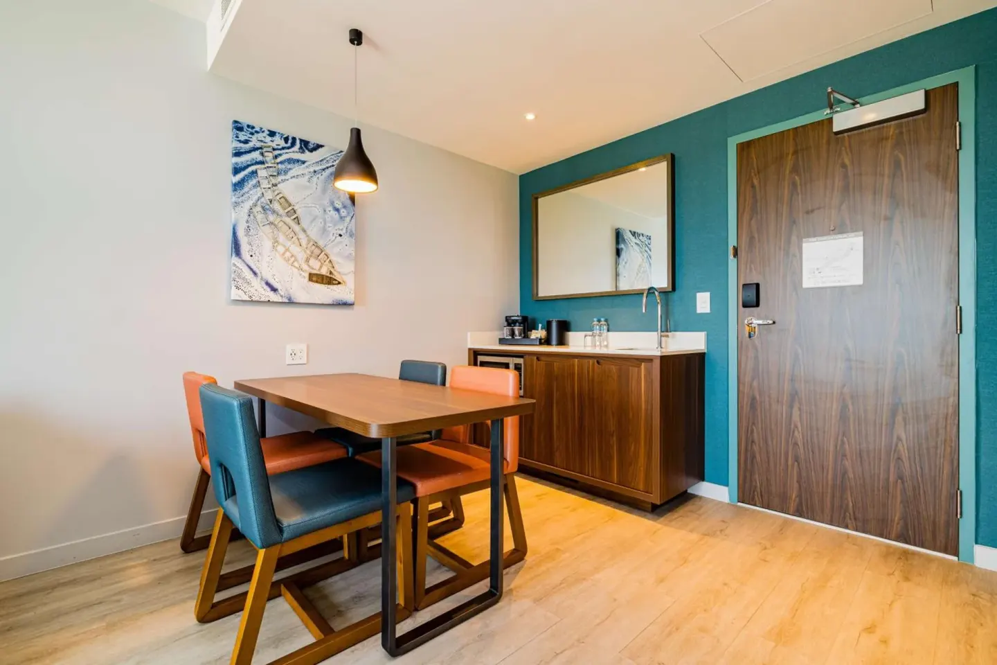 Suite dining nook with wet bar and entry door at Embassy Suites Aruba Beach Resort.
