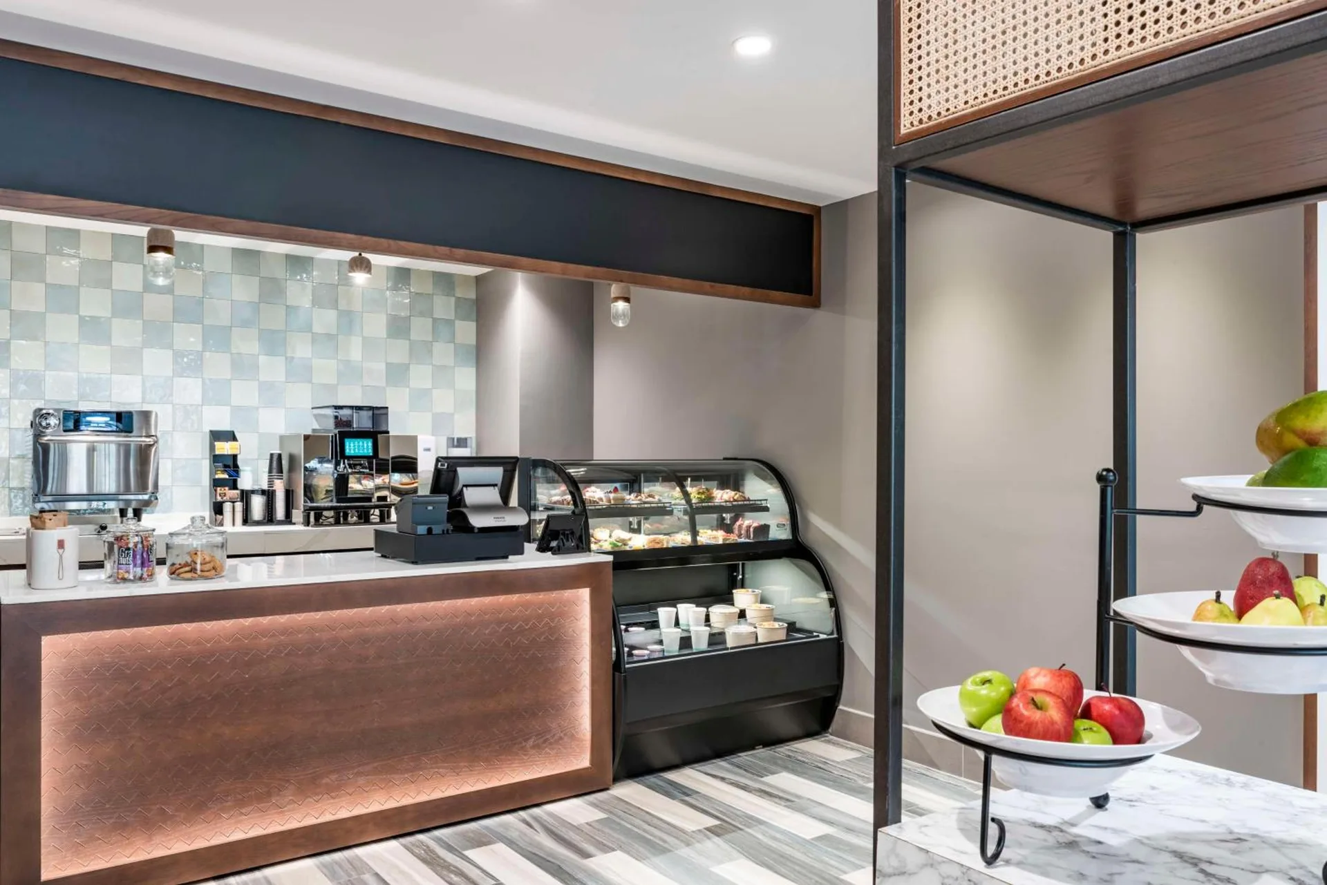 Grab-and-go cafe counter with pastry case at Embassy Suites Aruba Beach Resort.