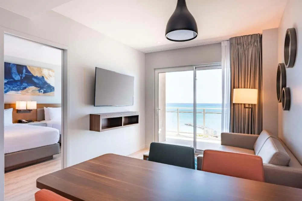 Oceanview 1 Bedroom Suite living area and bedroom at Embassy Suites Aruba Beach Resort.